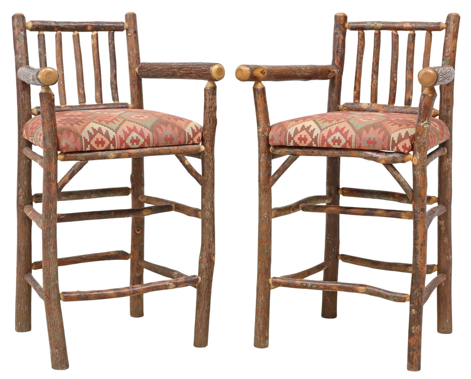(2) RUSTIC OLD HICKORY FURNITURE NATURAL BARK BARSTOOLS: (pair) Rustic Adirondack style barstools, attributed to Old Hickory Furniture, Shelbyville, Indiana, late 20th c., natural hickory sapling bark frame, fabric-covered slip seats in a kilim-type pa