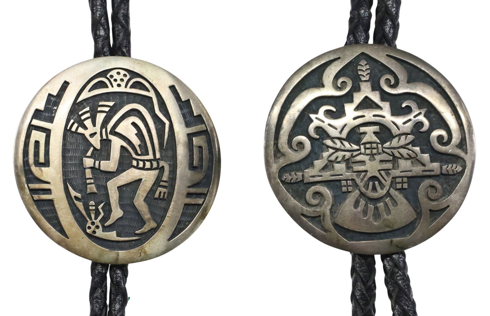 (2) ALDE QUMYINTEWA (1950-2004) HOPI SILVER OVERLAY BOLO TIES: (lot of 2) Native American sterling silver bolo ties, Alde Qumyintewa (Hopi, 1950-2004), silver overlay plaque, silver bolo tips, braided black leather cord, ornaments stamped sterling/ bear paw track
