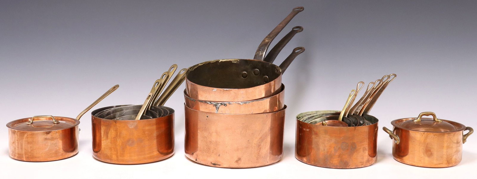 (17) FRENCH COPPER & METAL KITCHENWARE, GRADUATED SAUCEPANS: (lot of 17) French copper and metal graduated saucepans, four assembled sets, many marked Made in France at side, including: (5) Metaux Ouvres Vesoul, (5) with brass handle, (3) with long iron handle,