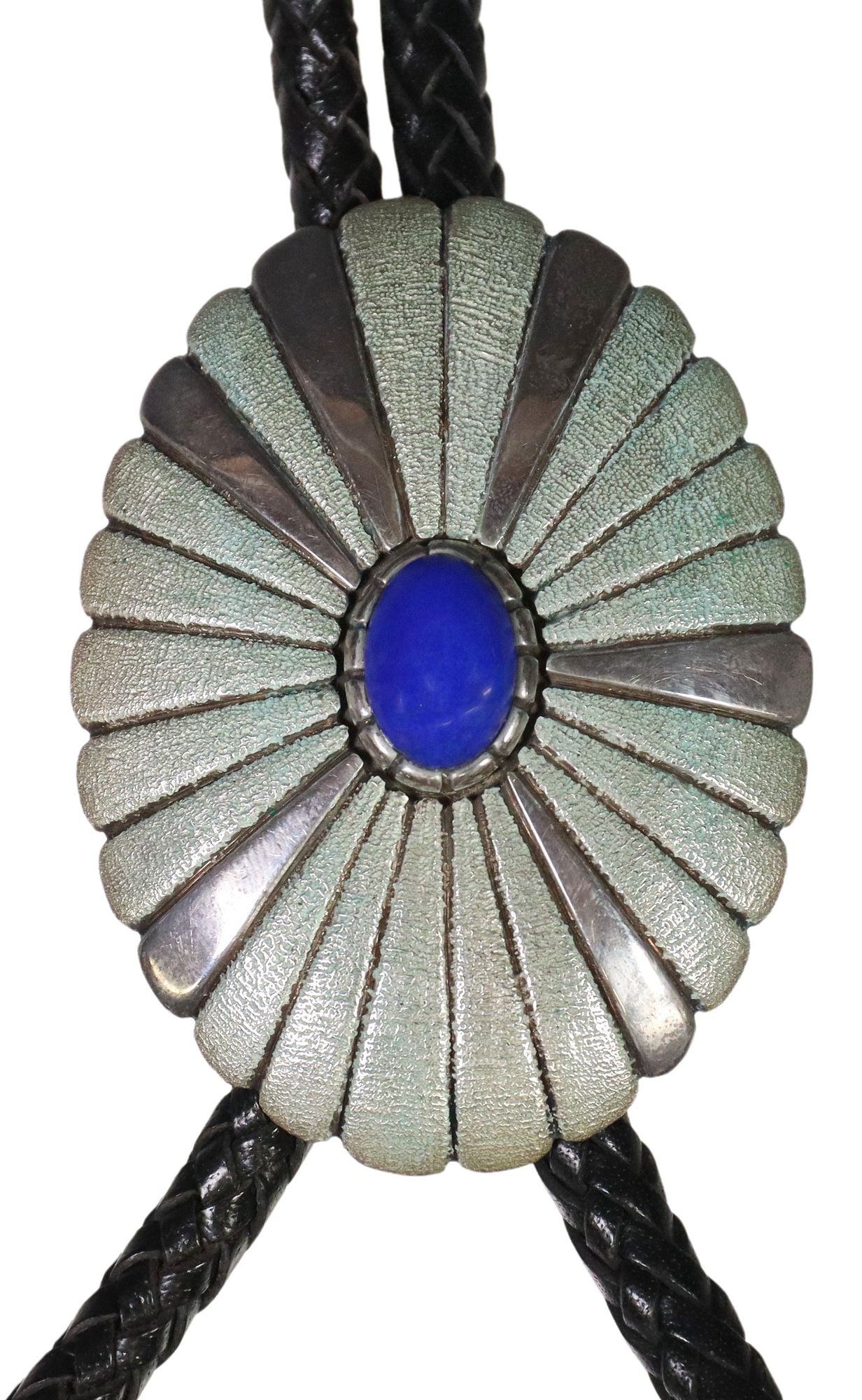 LARGE NATIVE AMERICAN L. BEGAY NAVAJO STERLING SILVER & LAPIS BOLO TIE: Large Native American sterling silver bolo tie, signed L. Begay (Navajo/ Dine) scalloped ovular ornament with central lapis lazuli cabochon, with matched silver tips, on braided black leather cord, bo
