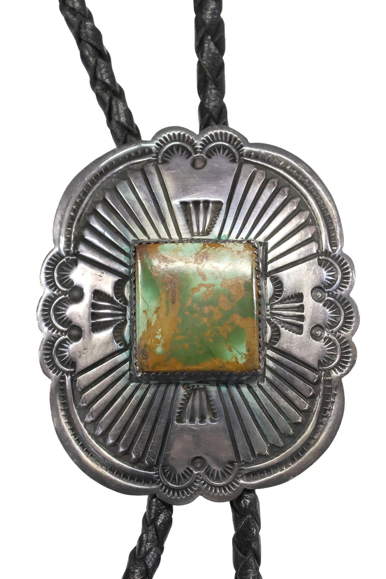 HARRISON BLACKGOAT (1939-1977) NAVAJO STERLING SILVER & TURQUOISE BOLO TIE: Native American sterling silver and turquoise bolo tie, signed H. Blackgoat (Harrison Blackgoat, Navajo/ Dine, 1939-1977), with square turquoise cabochon, surrounded by radiating stampwork motifs