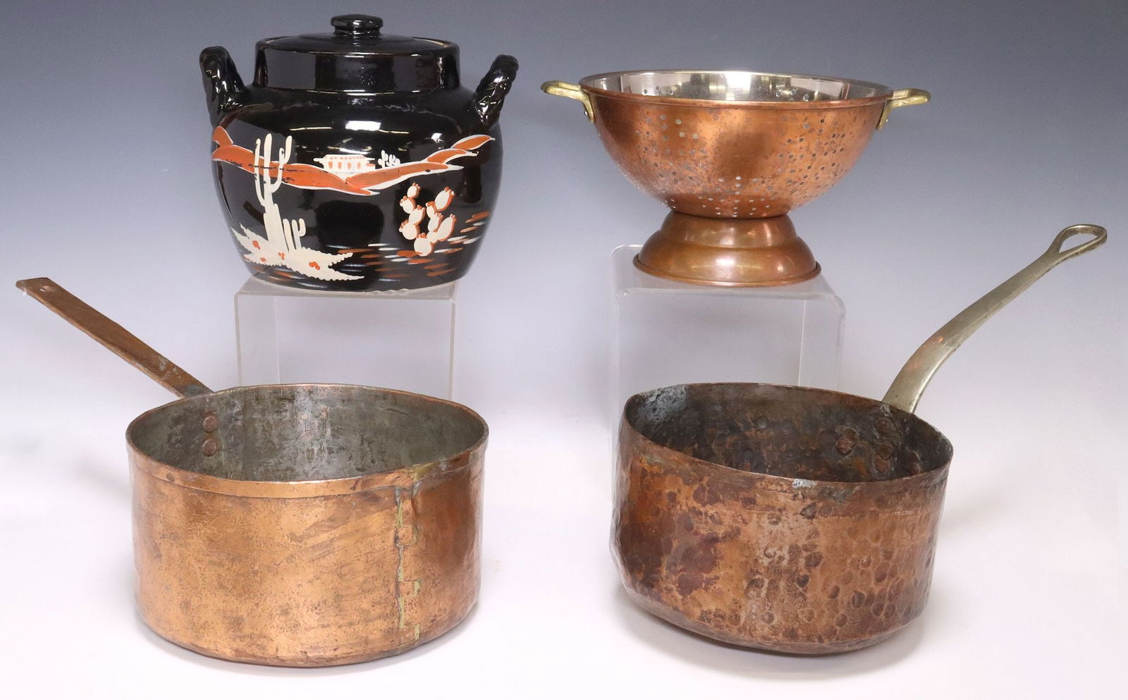 (4) RUSTIC KITCHENWARE, COPPER SAUCEPANS & STRAINER, SOUTHWEST STYLE JAR: (lot of 4) Rustic kitchenware, including: (2) copper and metal saucepans, largest: approx 4.75"h 18"w, 7.5"d; (1) copper strainer/ colander, with brass handles, approx 5.5"h, 11&qu