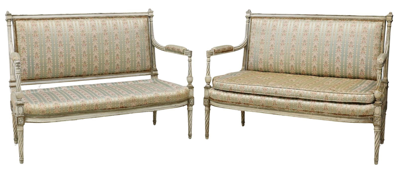 (2) FRENCH LOUIS XVI STYLE PAINTED CANAPES SETTEES: (pair) French Louis XVI style painted canapes/ settees, late 19th c., padded arms, back and seat covered in silk fabric, (one) accompanied by a button-tufted bench cushion, on tapering spiral-fluted l