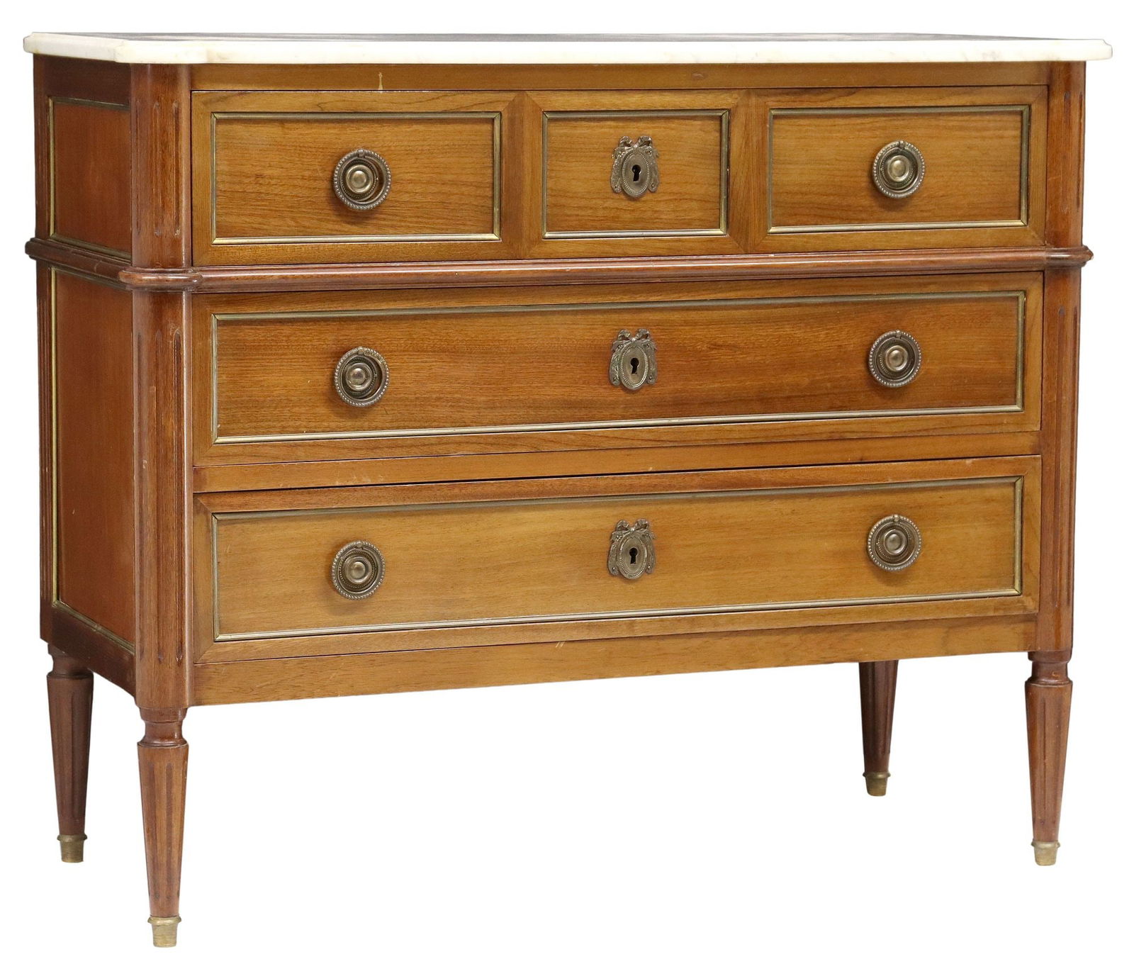 FRENCH LOUIS XVI STYLE MARBLE-TOP MAHOGANY COMMODE: French Louis XVI style mahogany commode, 20th c., having shaped marble top, over three drawers, flanked by fluted corner posts, rising on tapered legs, ending on brass cap feet, approx 33"h,