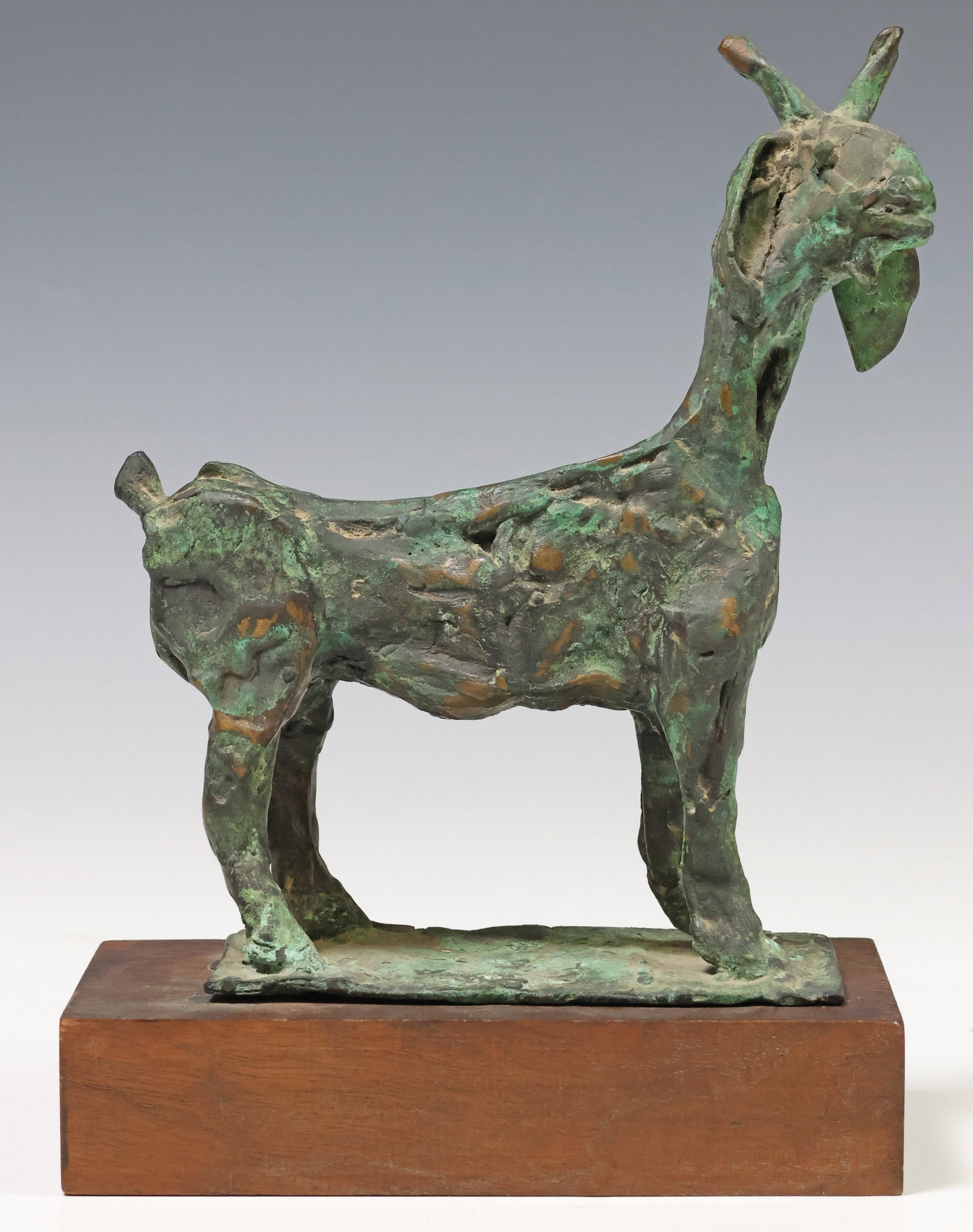 MODERNIST PATINATED BRONZE SCULPTURE OF A GOAT: Bronze sculpture in a verdigris patina, Goat, apparently unsigned, accompanied by a wood plinth, bronze: approx 8.25"h, plinth: approx 1.5"h, 7"w, 4"d, 7lbs total