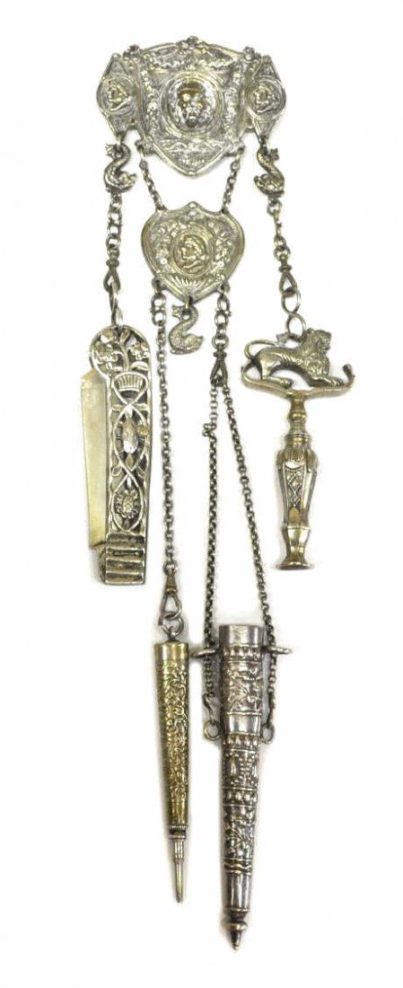 FINE CONTINENTAL SILVER CHATELAINE, FIGURAL DECOR: Continental silver chatelaine, testing as silver except for pencil tip and pin on knife, the hook featuring Roman profile reliefs and central figural mask amid swags of foliated garland, two outer cha