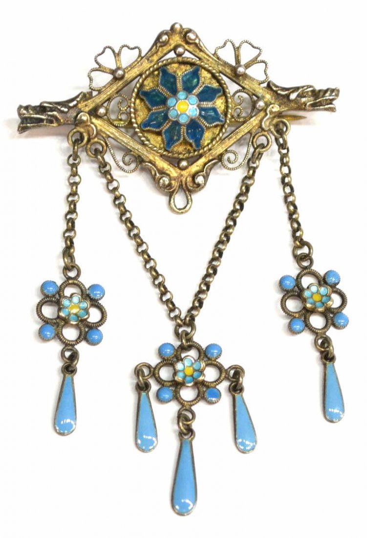 SCARCE NORWEGIAN MARIUS HAMMER SILVER ENAMEL PIN: Scarce Norwegian 830 silver enameled brooch, Marius Hammer (working Bergen, 1847-1927), the mask of a griffin / dragon on either end of the brooch centering a polychrome enamel floral head, dangling p