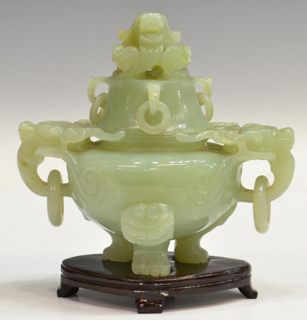 CHINESE GREEN JADE INCENSE BURNER: Chinese carved green jade incense burner on wood stand, the lid a dragon head, the handles dragon heads holding rings, set on claw feet, jade: 6"h, 6.25"w, 3.75"d, stand: .75"h, 4.75"w, 3.25"d, 2.5lbs