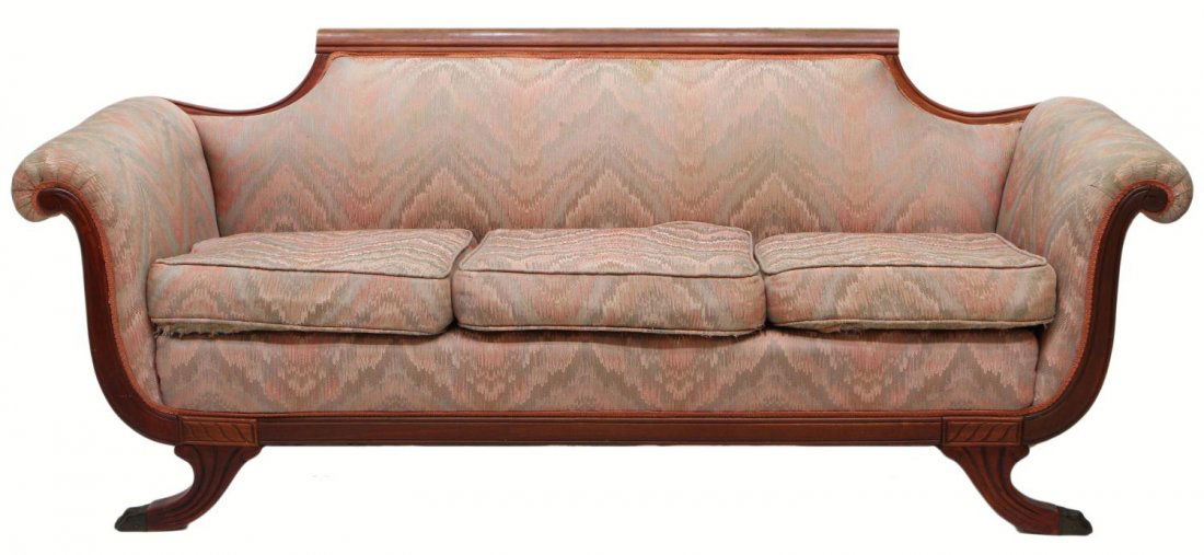 MAHOGANY FRAMED DUNCAN PHYFE SOFA: Mahogany framed Duncan Phyfe style sofa, c. 1900, with scrolled crest rail, later upholstery in worn condition, scrolled arms, arched legs terminating in brass feet, 31.5'h, 79"w, 31"d Start Price: $1