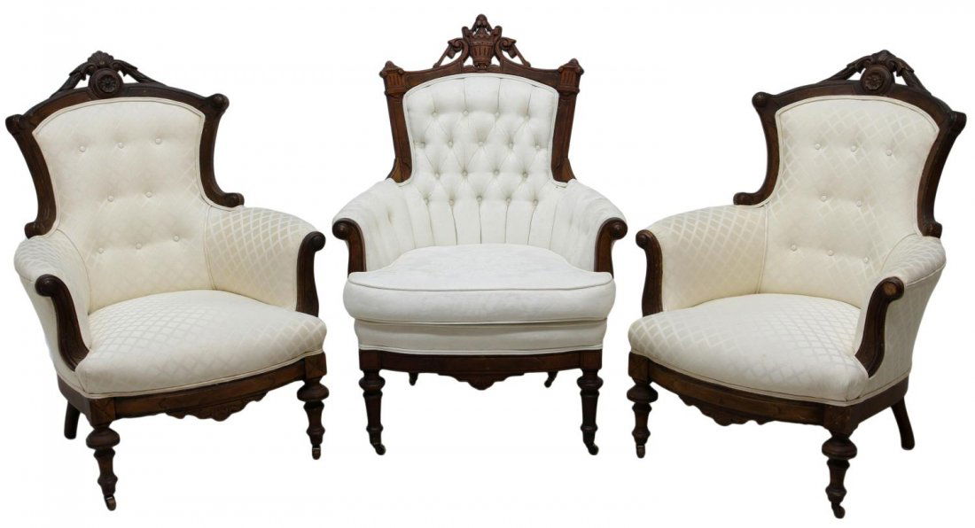 (3) EARLY AMERICAN VICTORIAN ARM CHAIRS: (lot of 3) American Victorian walnut arm chairs, c. 1860, each with later buttoned white on white upholstery: (2) pierced carved arched crest with scrolled side rails, rolled arms faced by scrolled wo