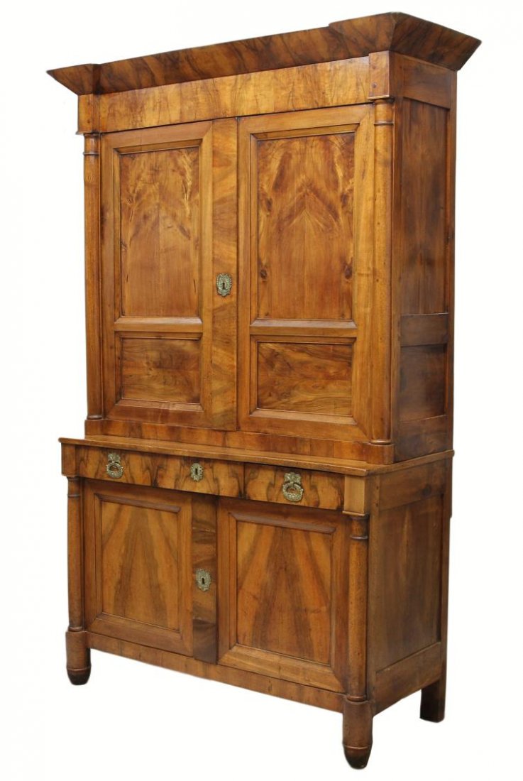 PROVINCIAL LOUIS PHILIPPE CUPBOARD, C. 1870: Provincial Louis Philippe cherry wood two part cupboard, c. 1870, an upward flared cornice over two doors, the lower cabinet with two frieze drawers over two doors, each section flanked by half column