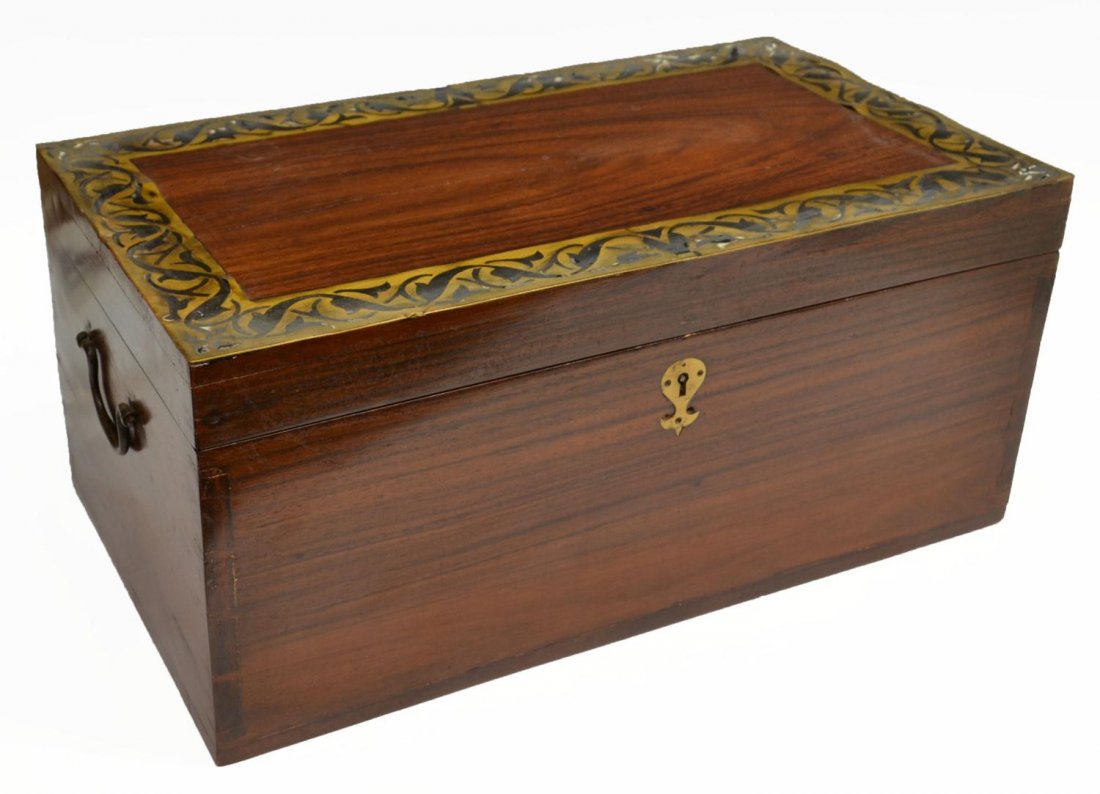 LARGE BRITISH COLONIAL BRASS MOUNTED TRAVEL BOX: British Colonial rosewood campaign box, c. 1900, the rectangular top mounted with foliated brass borders, fitted interior with removable tray, concealed drawers, and letter rack, side carry handles, s