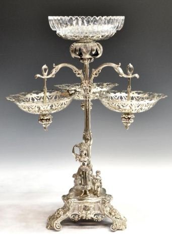 19TH C. ELKINGTON SILVERPLATE FIGURAL CENTERPIECE: Monumental Victorian silvered tazza centerpiece, Elkington & Company, Birmingham, April 1851, the shallow cut glass bowl resting on a pierced platform above thee foliated branches holding elaborately 