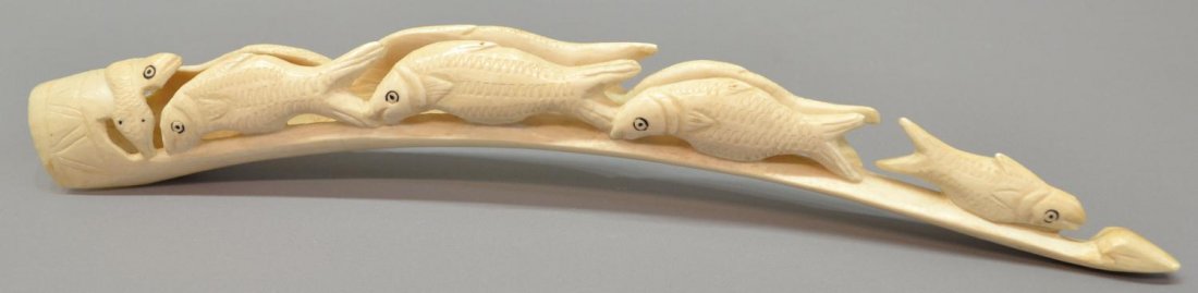 AFRICAN CARVED IVORY TUSK, FISH, SNAKE, FROG: *International shipping is not available on this lot* African ivory carving, the curved tusk carved on either side with fish and snake, 12.5"l, .25lb ** Provenance: From the San Anselmo Estate of a Da
