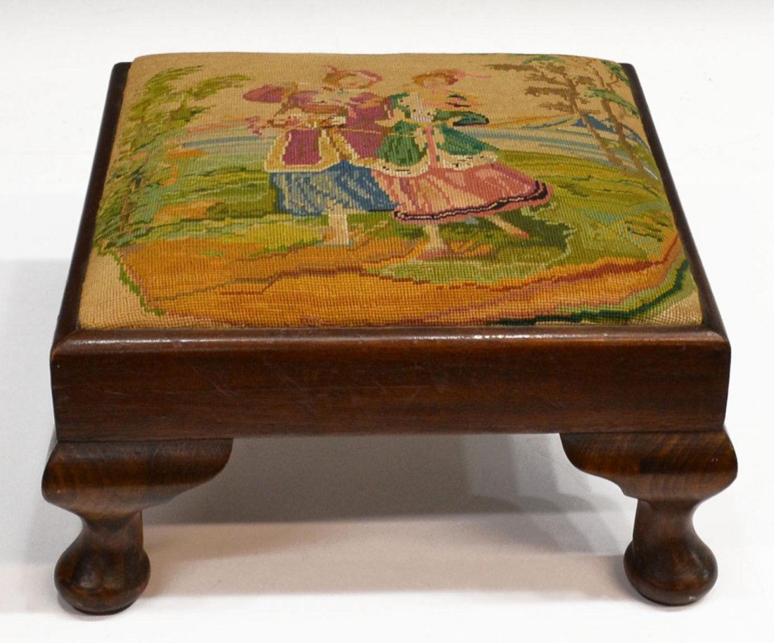 QUEEN ANNE STYLE TAPESTRY UPHOLSTERED FOOTSTOOL: Queen Anne style walnut footstool, first half 20th c., tapestry cushion showing a courting scene, some wear, 7"h, 12.5"w, 12.5"d, Start Price: $40.00