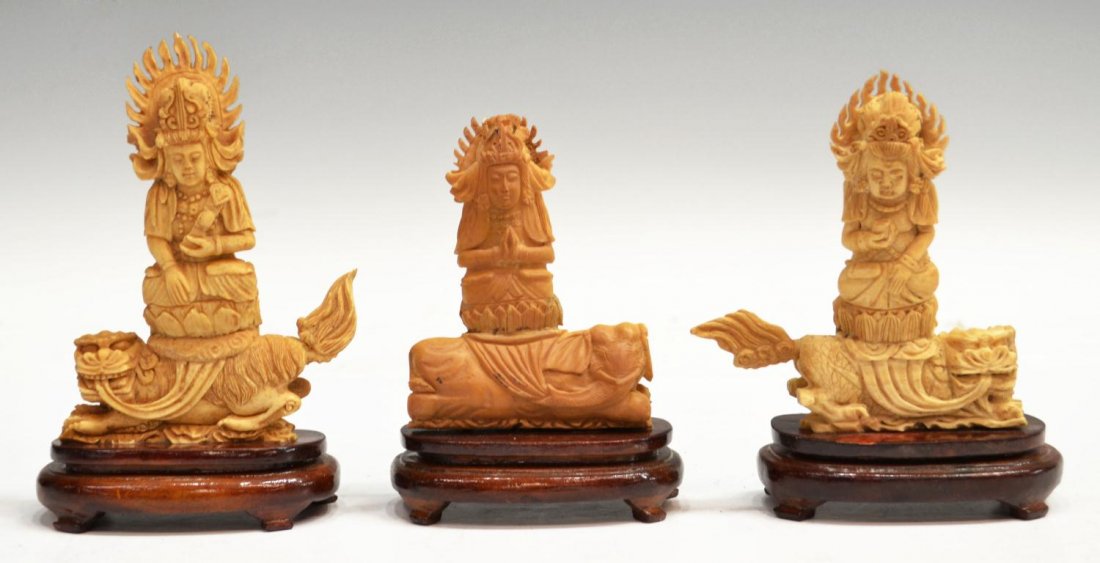 (3) CARVED BONE BUDDHIST FIGURES: (lot of 3) Carved Buddhist figures on wood stands, in three poses: (1) holding a rui scepter; (1) holding cup; (1) one with hands clasped, chips at crown, largest: 5.7/8"h, 4"w, 2"d, housed in box: 3.