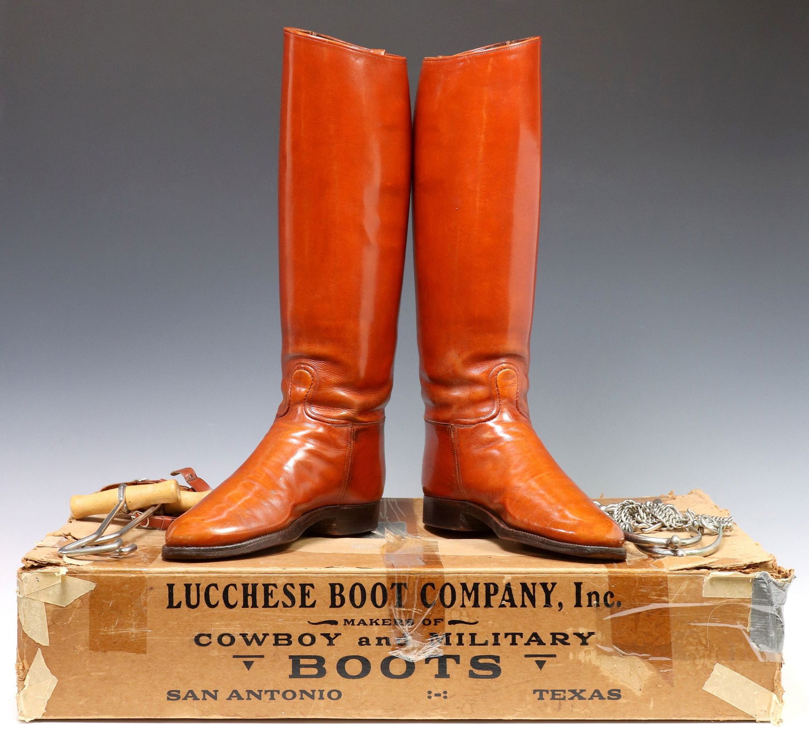 (2) LUCCHESE TEXAS A&M SENIOR CADET RIDING BOOTS & AUGUST BUERMANN SPURS: (lot of 2) Collegiate cadet riding boots and spurs, (pair) Vintage Lucchese brown leather military cadet uniform riding boots, having tall shaft with upper buckle fastener, marked Lucchese Boot C