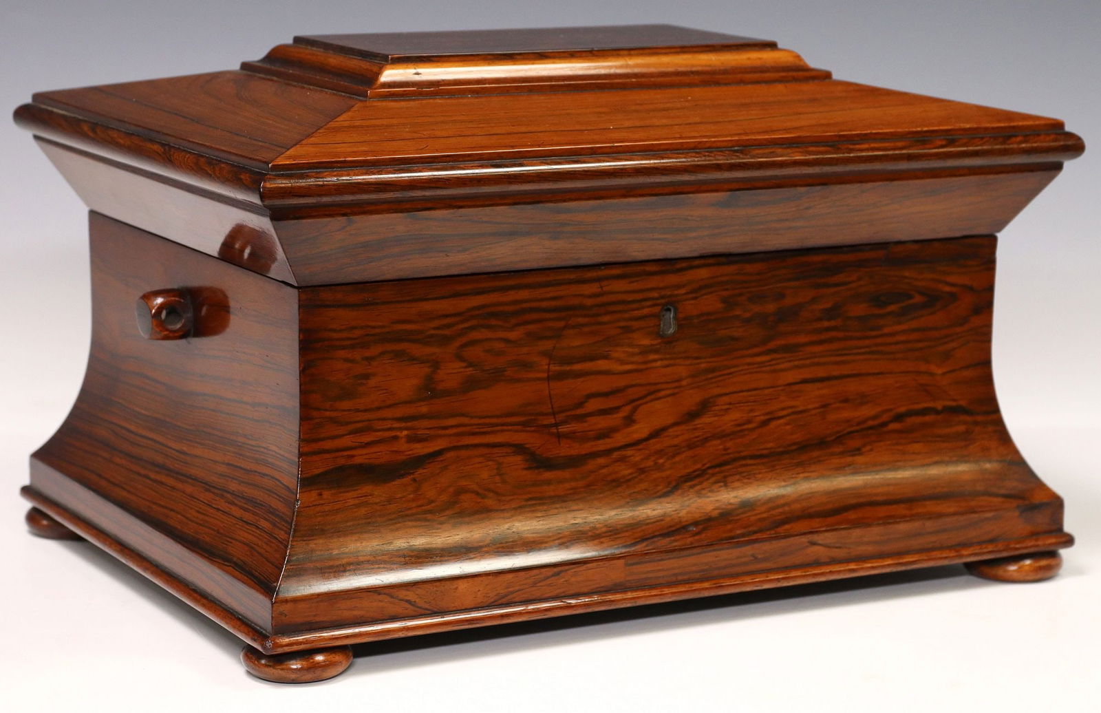 ENGLISH REGENCY SARCOPHAGUS-FORM ROSEWOOD SEWING BOX: English Regency rosewood sewing box, early 19th c., of sarcophagus form, hinged lid with accordioned interior lined in blue satin with applique quilting, interior fitted with loose divided t