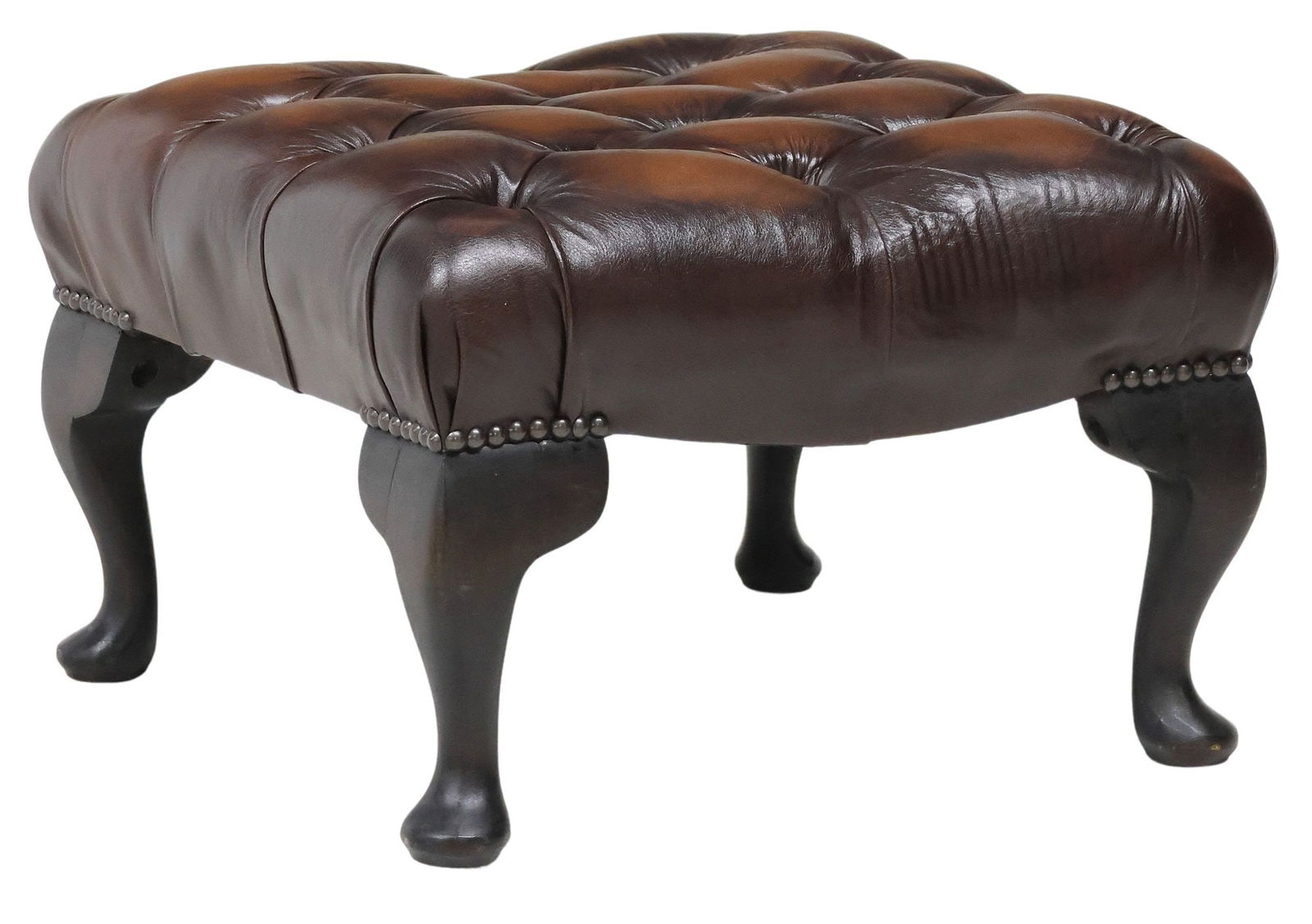 ENGLISH CHESTERFIELD STYLE BUTTON-TUFTED BROWN LEATHER STOOL: English Chesterfield style stool, 20th c., in button-tufted brown leather upholstery, with nailhead trim, rising on cabriole legs, approx 13.25"h, 19.5"w, 19"d