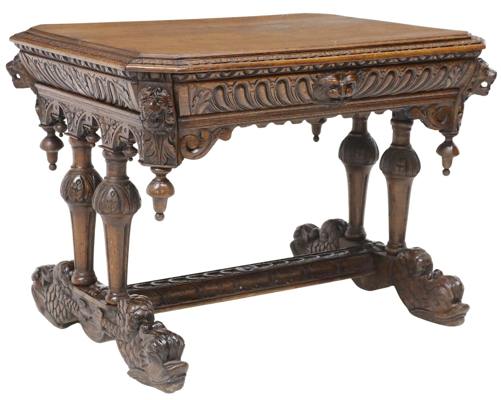 FRENCH RENAISSANCE REVIVAL CARVED OAK WRITING TABLE: French Renaissance Revival carved oak writing table, late 19th c., rectangular top with molded edge, above a carved lion's mask at each corner, single frieze drawer, pairs of tapering fluted suppo