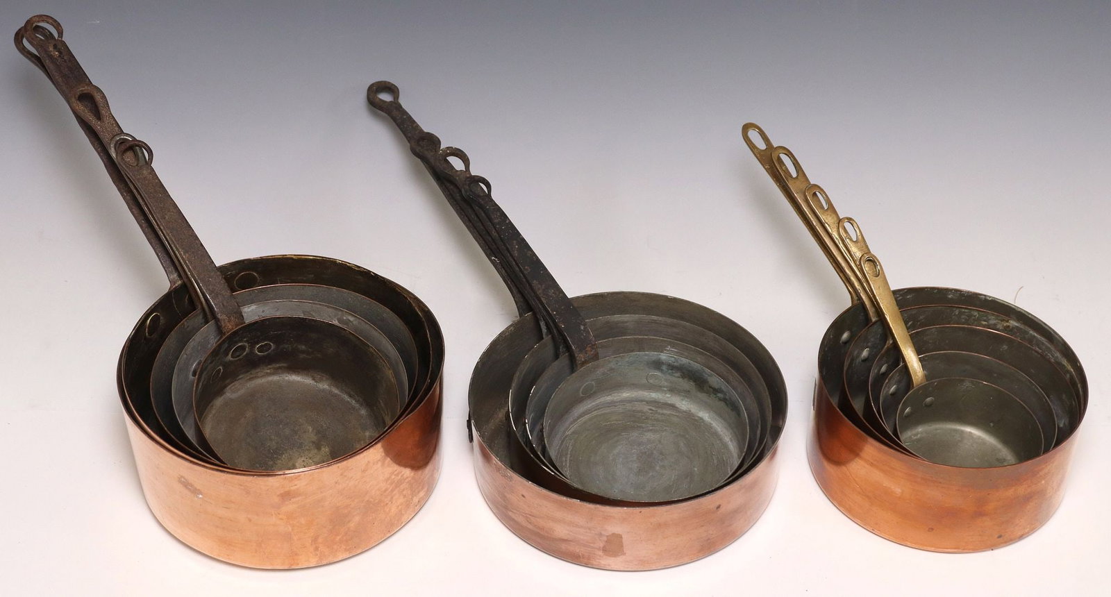 (14) FRENCH GRADUATED COPPER SAUCEPANS, 3 ASSEMBLED SETS: (lot of 14) French graduated copper saucepans, three assembled sets, including: (5) assembled set, (one) marked Les Cuivres de Faucogney, (5) marked Made in France at side, (4) shallow saucepans, larg