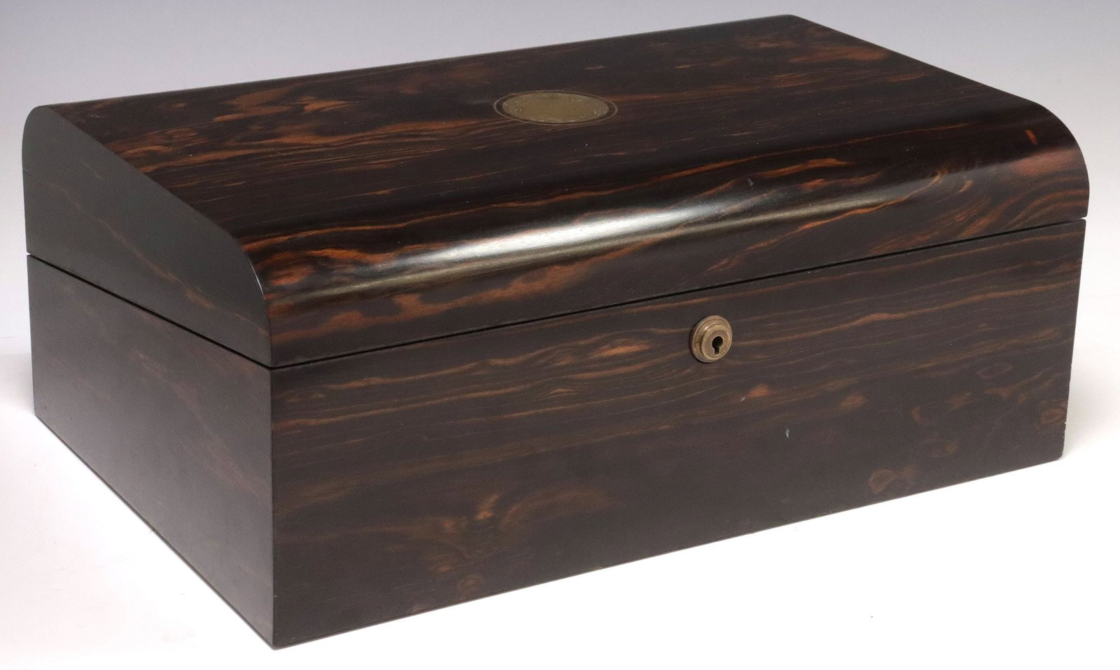 FINE ENGLISH COROMANDEL WRITING SLOPE/ TRAVEL DESK: English calamander/ coromandel writing slope/ travel desk, late 19th c., domed top with central vacant brass roundel, opening to pen and ink receptacles, retaining two glass ink bottles, and divi