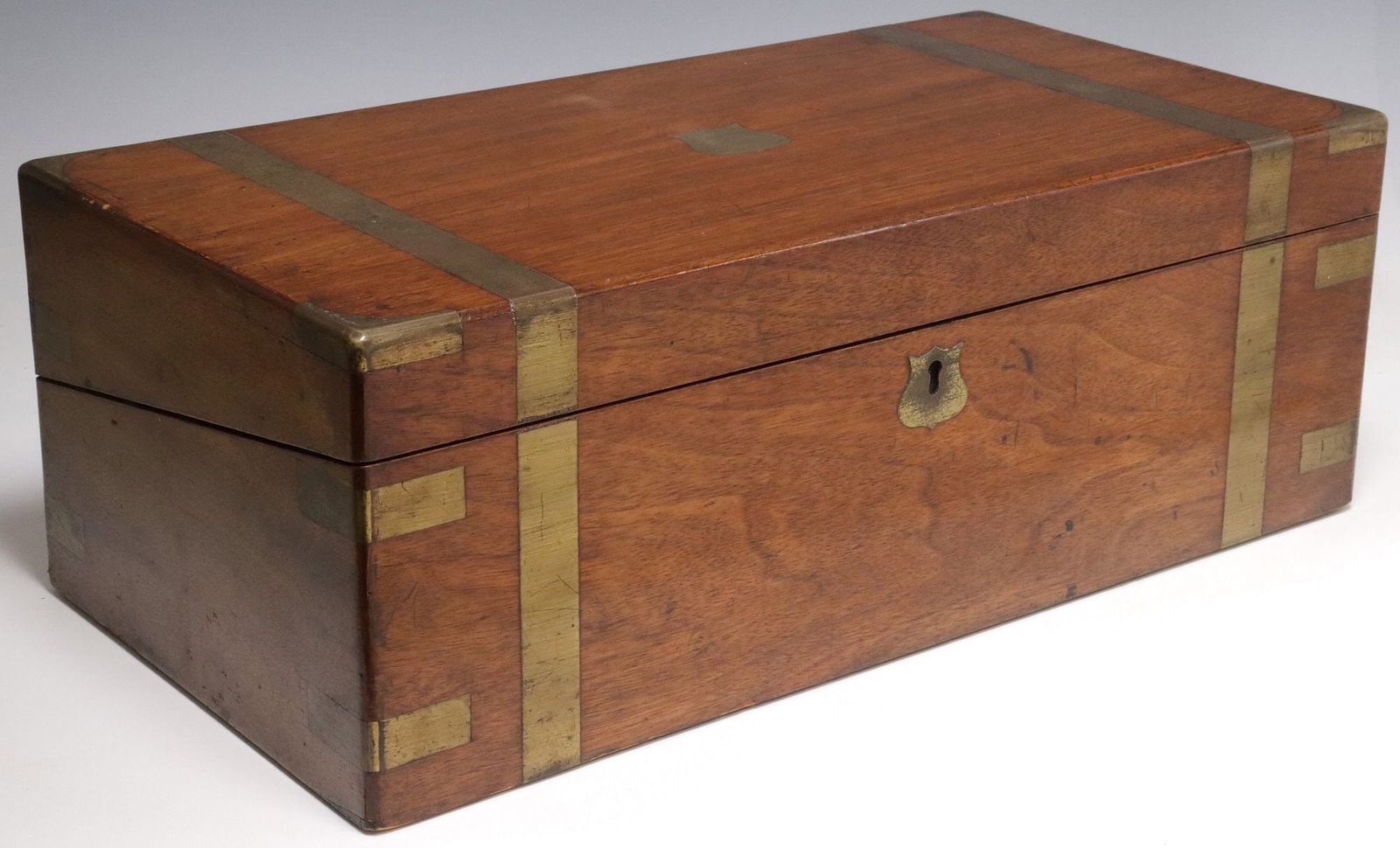 ENGLISH BRASS-BOUND WRITING SLOPE/TRAVEL DESK, DATED 1884: English brass-bound writing slope/ travel desk, late 19th c., hinged lid with central shield-form cartouche inscribed, "Presented to Mr. James Fleming by his fellow clerks as a token of resp