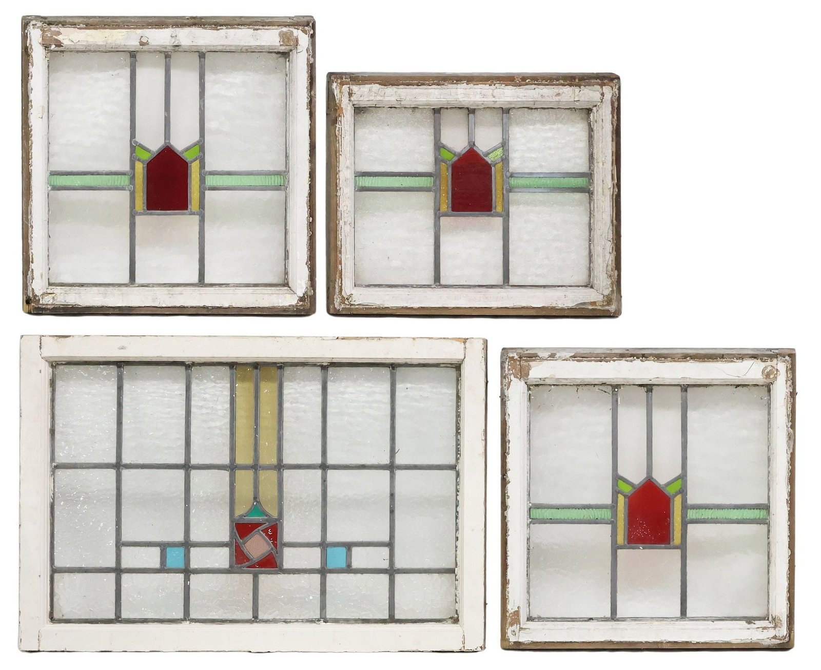 (4) ENGLISH STAINED & LEADED GLASS ARCHITECTURAL WINDOWS: (lot of 5) English architectural stained and leaded glass windows, early 20th c., worn white painted wood frames, encasing clear and polychrome textured glass panels, of varied geometric designs, larg