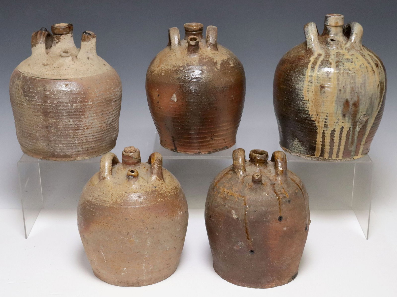 (5) FRENCH PROVINCIAL STONEWARE OIL JUGS: (lot of 5) French Provincial stoneware oil jugs, each with dual side handles, and partial glazed decoration, largest: approx 9.75"h, 8"diam, 22.5lbs total