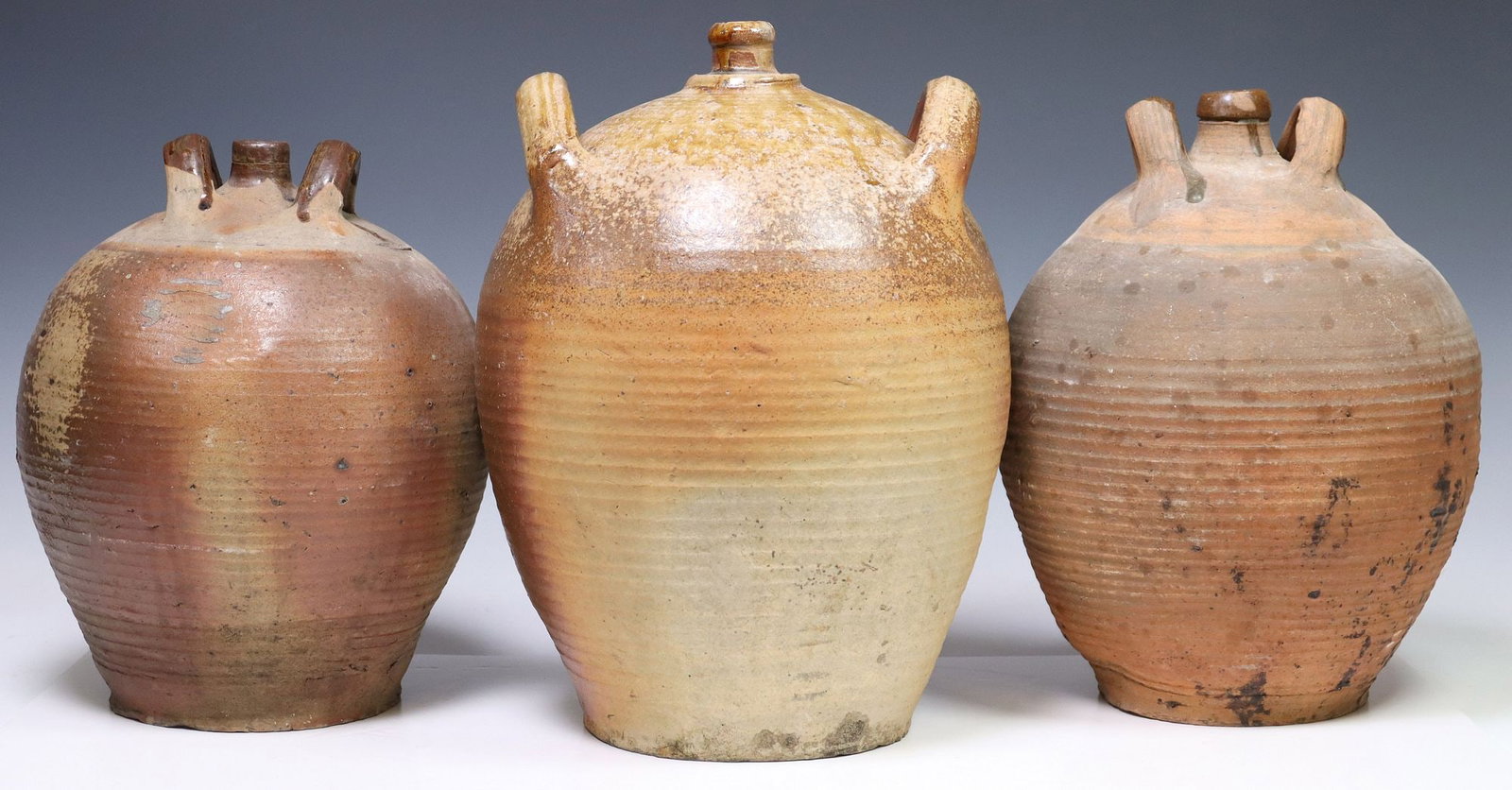 (3) FRENCH PROVINCIAL STONEWARE OIL JUGS: (lot of 3) French Provincial stoneware oil jugs, each with dual handles and narrow spout, over tapered body, largest: approx 14.5"h, 10.5"diam, 26.25lbs total
