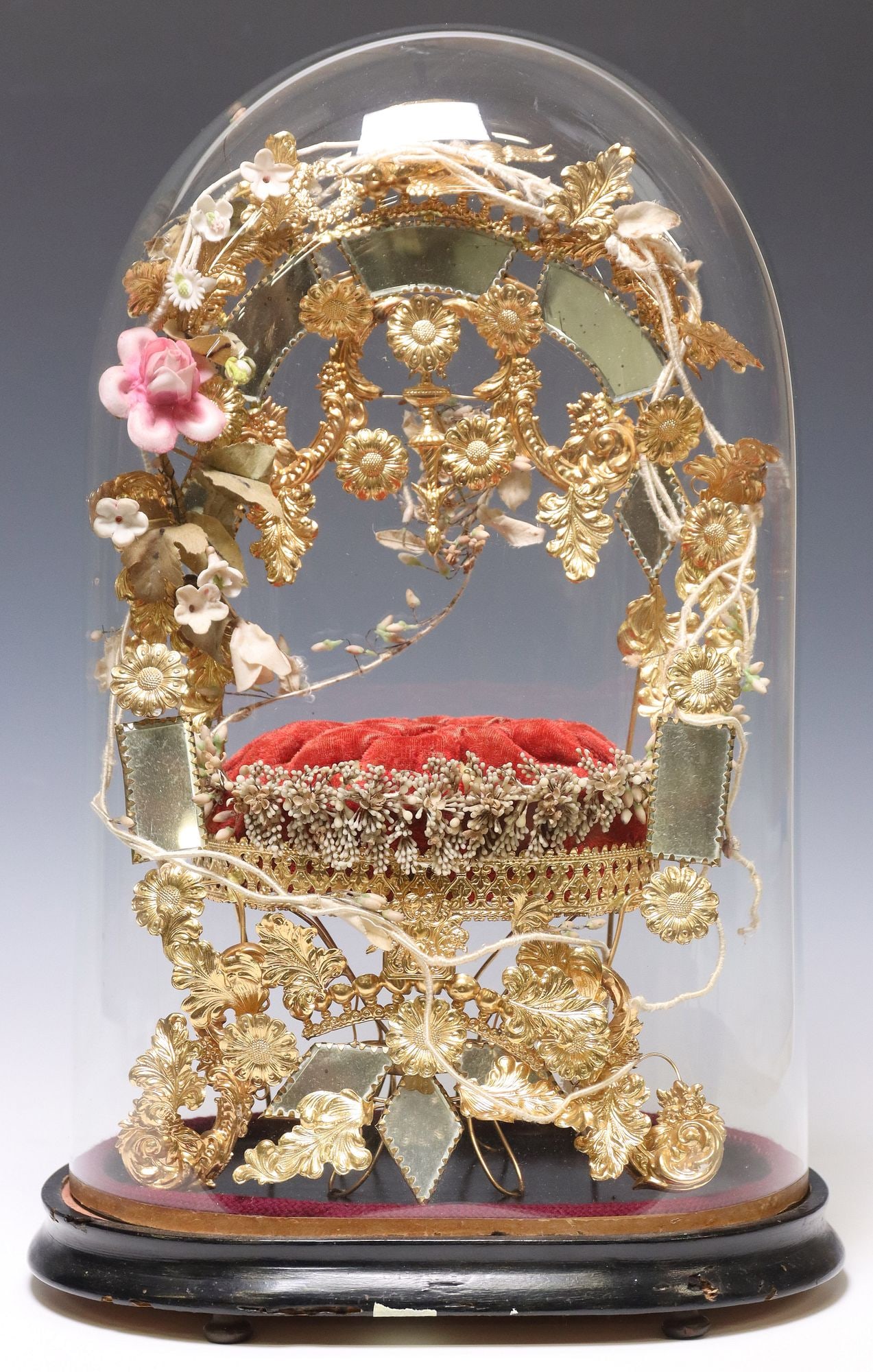 FRENCH GLOBE DE MARIEE / BRIDE'S GLOBE IN GLASS CLOCHE: French globe de mariee/ bride's globe, late 19th c., glass cloche/ dome on ebonized base, enclosing gilt metal frame, with central mirror plates and floral motifs, on tufted cushion, overall: appr