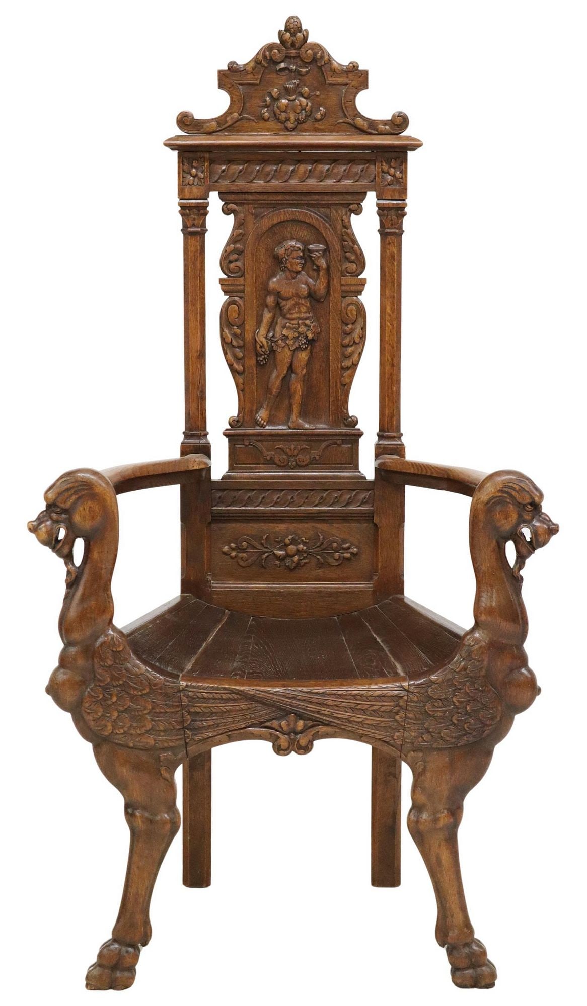 RENAISSANCE REVIVAL FINELY CARVED FIGURAL ARMCHAIR: Renaissance Revival ornately carved armchair, early 20th c., having top crest with scrolled designs, back panel with Bacchanalian figure, arms terminating in handholds carved as winged grotesque figur