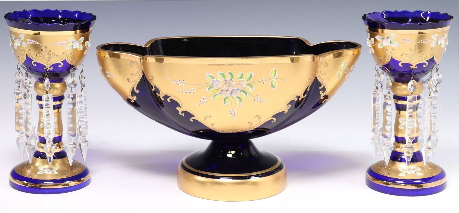 (3) MURANO PARCEL GILT & COBALT GLASS MANTEL LUSTERS & CENTER BOWL: (lot of 3) Italian Murano cobalt art glass mantel garniture set, 20th c., each having parcel gilt overlay with enameled flowers, including: (1) centerpiece bowl, having shaped basin over circular
