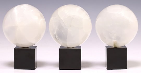 (3) GEOLOGICAL MOROCCAN SELENITE SPHERES ON BLACK MARBLE BASE