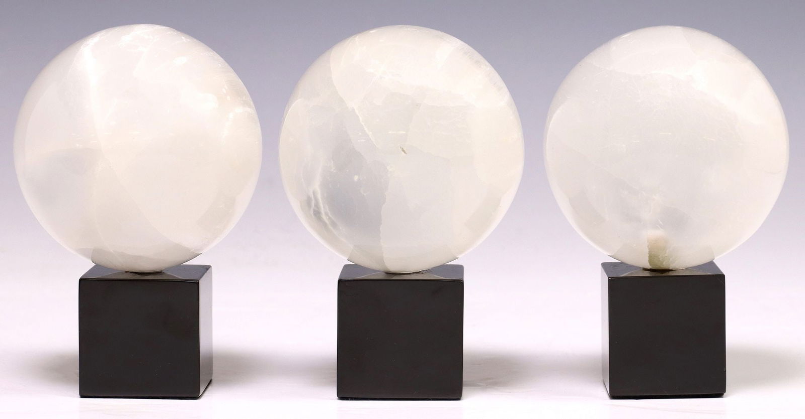 (3) GEOLOGICAL MOROCCAN SELENITE SPHERES ON BLACK MARBLE BASE (1 of 3)