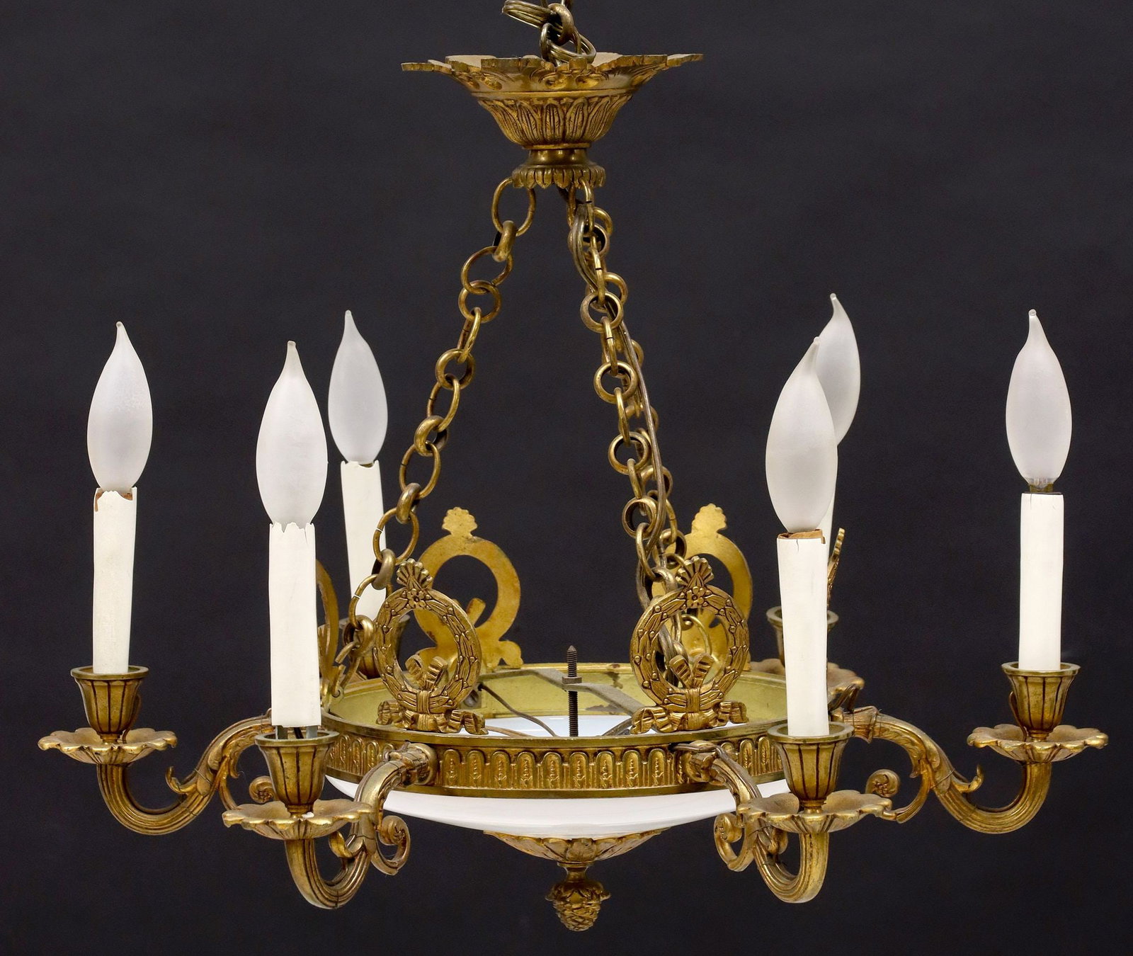 EMPIRE STYLE GILT BRONZE & OPALINE GLASS SIX-LIGHT CHANDELIER: Empire style gilt bronze six-light chandelier, 20th c., having shallow white-colored milk glass shade, mounted with arcaded gilt metal trim and wreath with ribbon motifs, issuing six scrolled arms, te