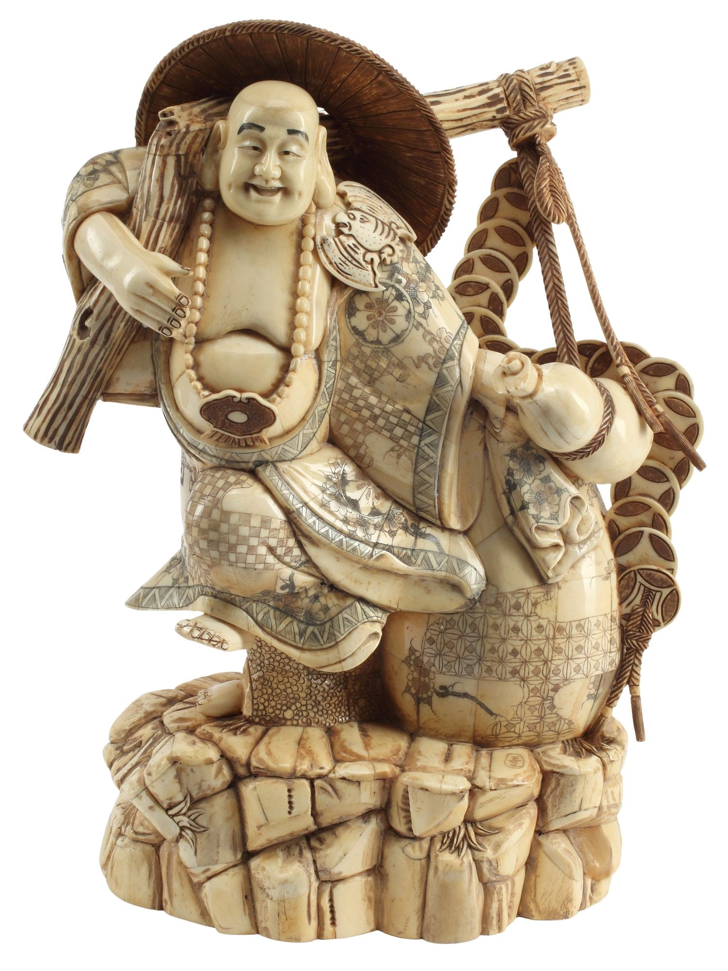 CARVED BONE-TILED OKIMONO BUDDHIST MONK HOTEI: Carved bone-tiled figure of the Buddhist monk Hotei, depicted with various ritual implements, on integral naturalistic rock-form base, incised character mark, approx 16"h, 12"w, 6&