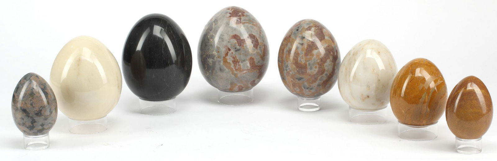 (8) CARVED MARBLE EGGS ON CLEAR ACRYLIC STANDS: (lot of 8) Carved marble eggs on colorless acrylic bases, largest: approx 6"h, 5"diam