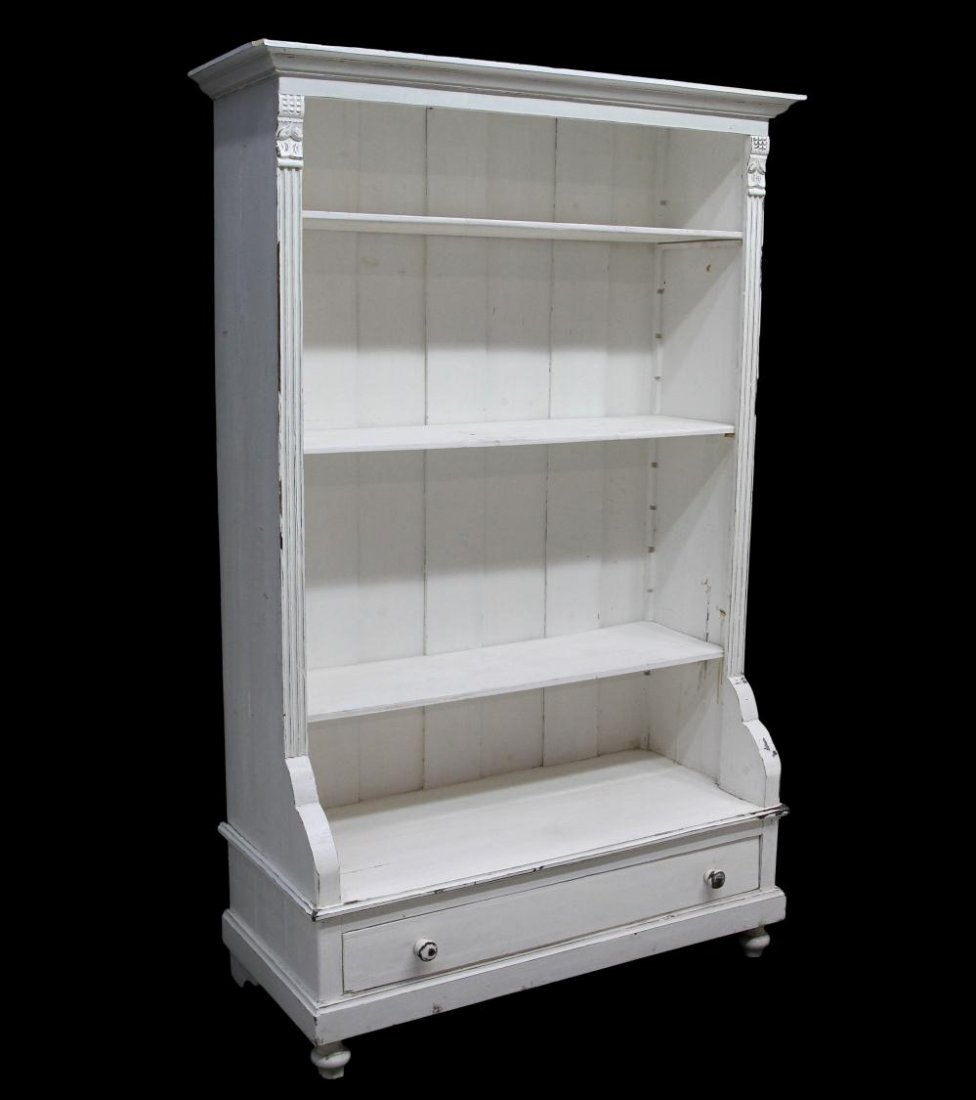 ANTIQUE DANISH PAINTED WHITE PINE BOOKCASE, 19TH C: Antique pine bookcase in white paint, Denmark, c. 1900, a stepped cornice over open adjustable height book shelves, the lower cabinet protruding out over a single drawer, rising on blunt arrow feet, p