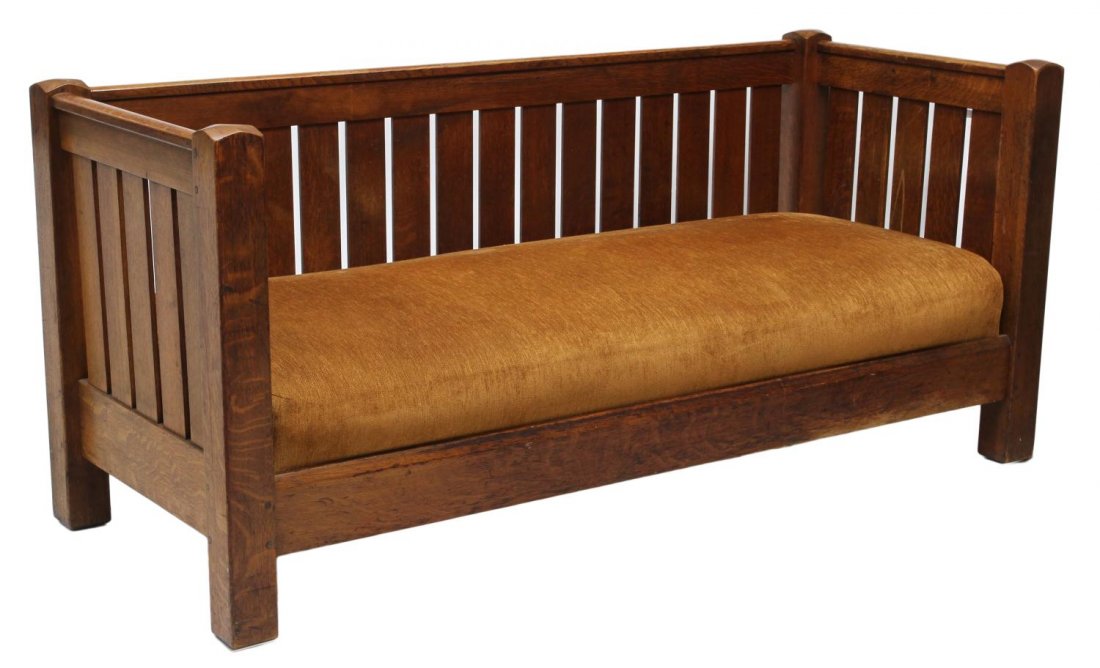 L & JG STICKLEY OAK SETTLE #281, STICKLEY TAG: L& JG Stickley oak settle, vertical slat supported back and side rails, spring cushion and pillows with later upholstery, makers paper tag remnant at outside of back seat rail reading The Work of L&JG