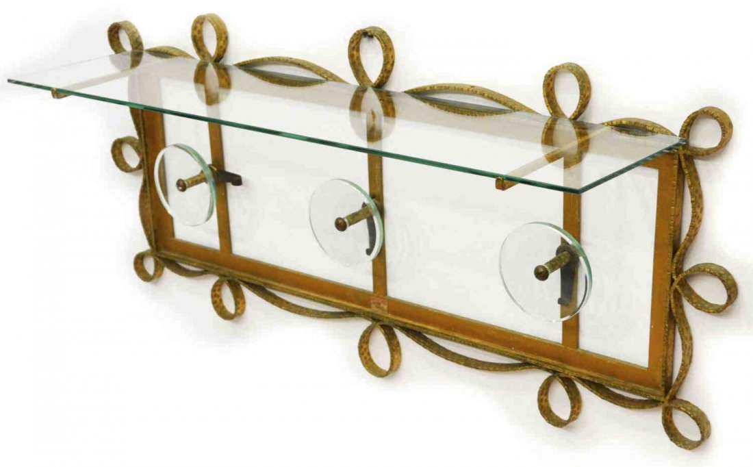 VINTAGE ITALIAN GILT METAL HAT RACK PIERLUIGI COLLI: Italian gilded iron metal hat rack attributed to Pierluigi Colli, a scrolled and straight steel frame with protruding upper glass shelf, and three circular glass coat hooks, 16Æh, 40öw, 10öd Start