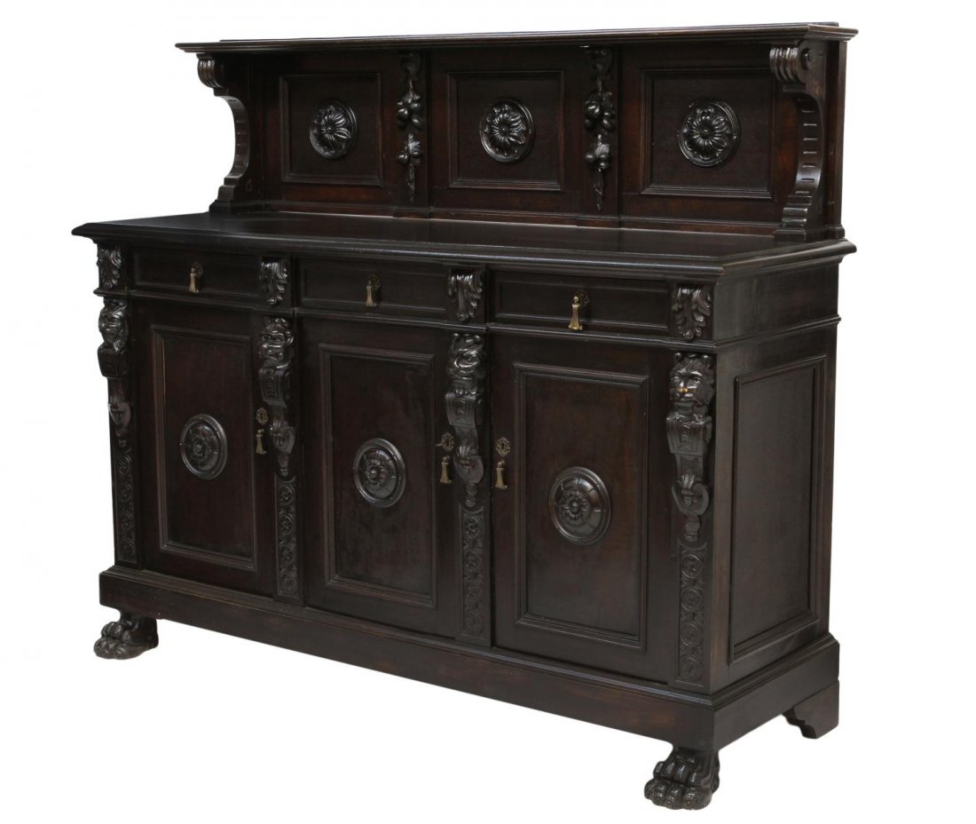 ITALIAN RENAISSANCE REVIVAL SIDEBOARD: Italian Renaissance Revival sideboard, late 19th c., ebonized finish with foliate, floral and mask decoration, a splash back set on the rectangular top, three frieze drawers over three doors, rising o