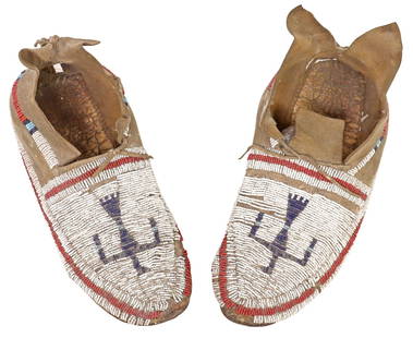 (PAIR) NATIVE AMERICAN CHEYENNE BEADED HIDE MOCCASINS: (pair) Native American Cheyenne beaded moccasins, late 19th/ early 20th c., in tanned hide, the vamp with a stylized Thunderbird motif, some typical bead loss, some tears and separation to soles,