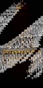 ITALIAN EMPIRE STYLE SAC-A-PEARL 1-LIGHT CRYSTAL CHANDELIER: Italian Empire style single-light sac-a-pearl crystal chandelier, 20th c., having fanned foliate crest, over tiered circular frame hung with crystal beaded swags and prisms, typical small chips a