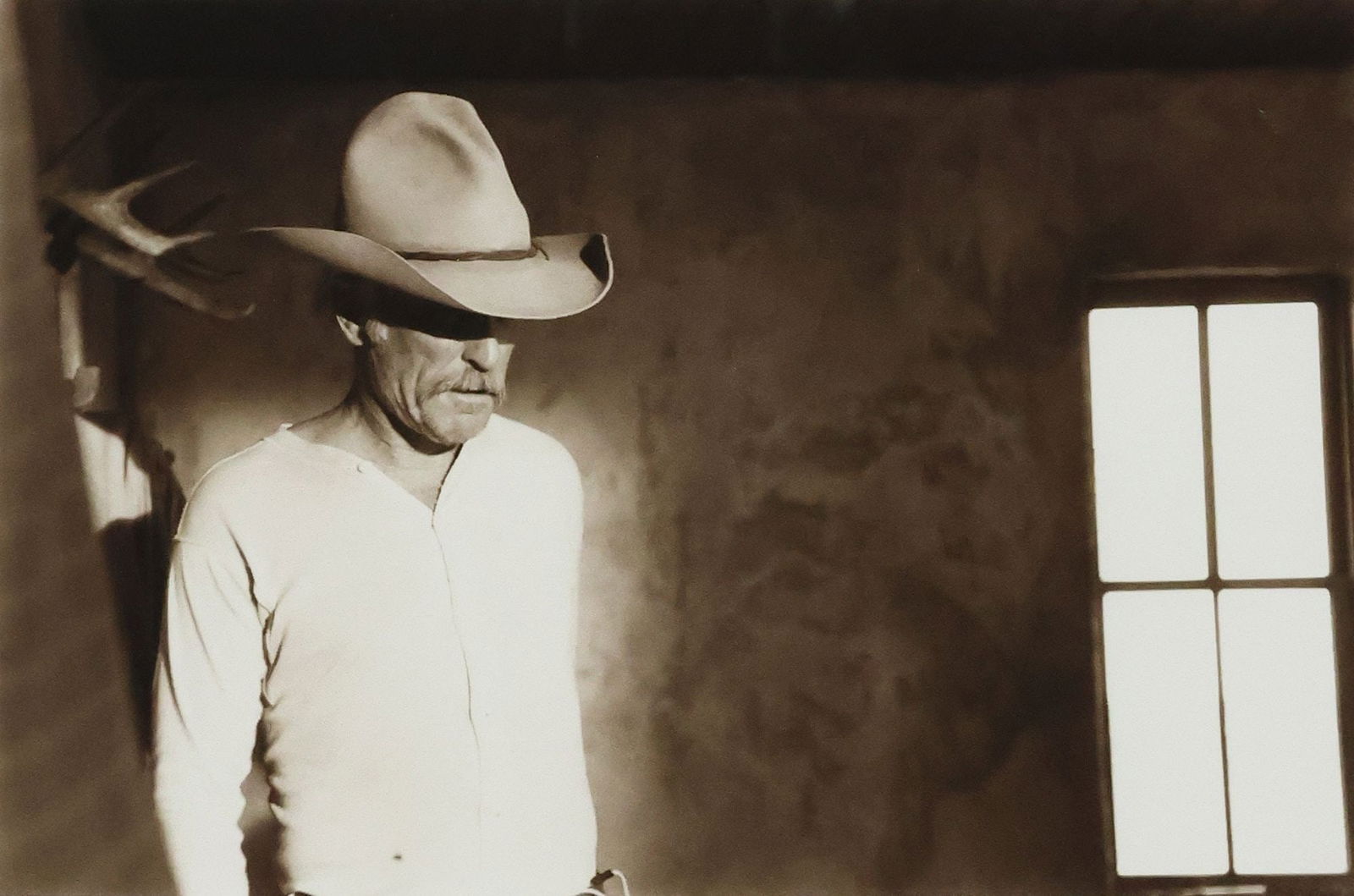 BILL WITTLIFF (1940-2019) TONED GELATIN SILVER PRINT LONESOME DOVE: Framed sepia-toned gelatin silver print on Agfa paper, "Gus - Lonesome Dove - Del Rio" (Robert Duvall as Augustus 'Gus' McCrae), signed lower right Bill Wittliff (William Dale Wittli