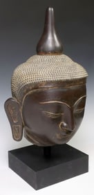 LARGE SOUTHEAST ASIAN PARCEL-GILT HARDWOOD HEAD OF BUDDHA
