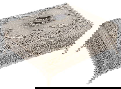 DECORATIVE SILVERED METAL JEWELRY BOX: Decorative silvered metal jewelry box, 20th c., hinged cover with faceted black inset, velvet-lined interior, on four bracket feet, approx 4.25"h, 8.75"w, 7.5"d, 2.5lbs (for shipping