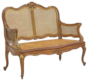 FRENCH LOUIS XV STYLE PARCEL GILT CANED WALNUT SALON SETTEE