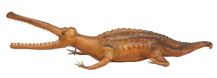 LARGE FOLK ART LEATHER-CLAD ALLIGATOR SCULPTURE, 65"L: Large folk art leather-clad alligator sculpture, with inset glass eyes and white teeth, tonal patinated tan leather cladding and raised scutes, small losses to teeth and toes, approx