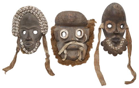 (3) AFRICAN COTE D'IVOIRE CARVED MASKS: (lot of 3) African carved wood masks, all likely from the&nbsp;Ivory Coast/ Liberia region, including: (2) likely Dan peoples, each with applied cowry shells and natural materials, one with rattles fr